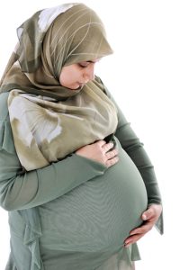 Pregnant muslim woman with happy expression