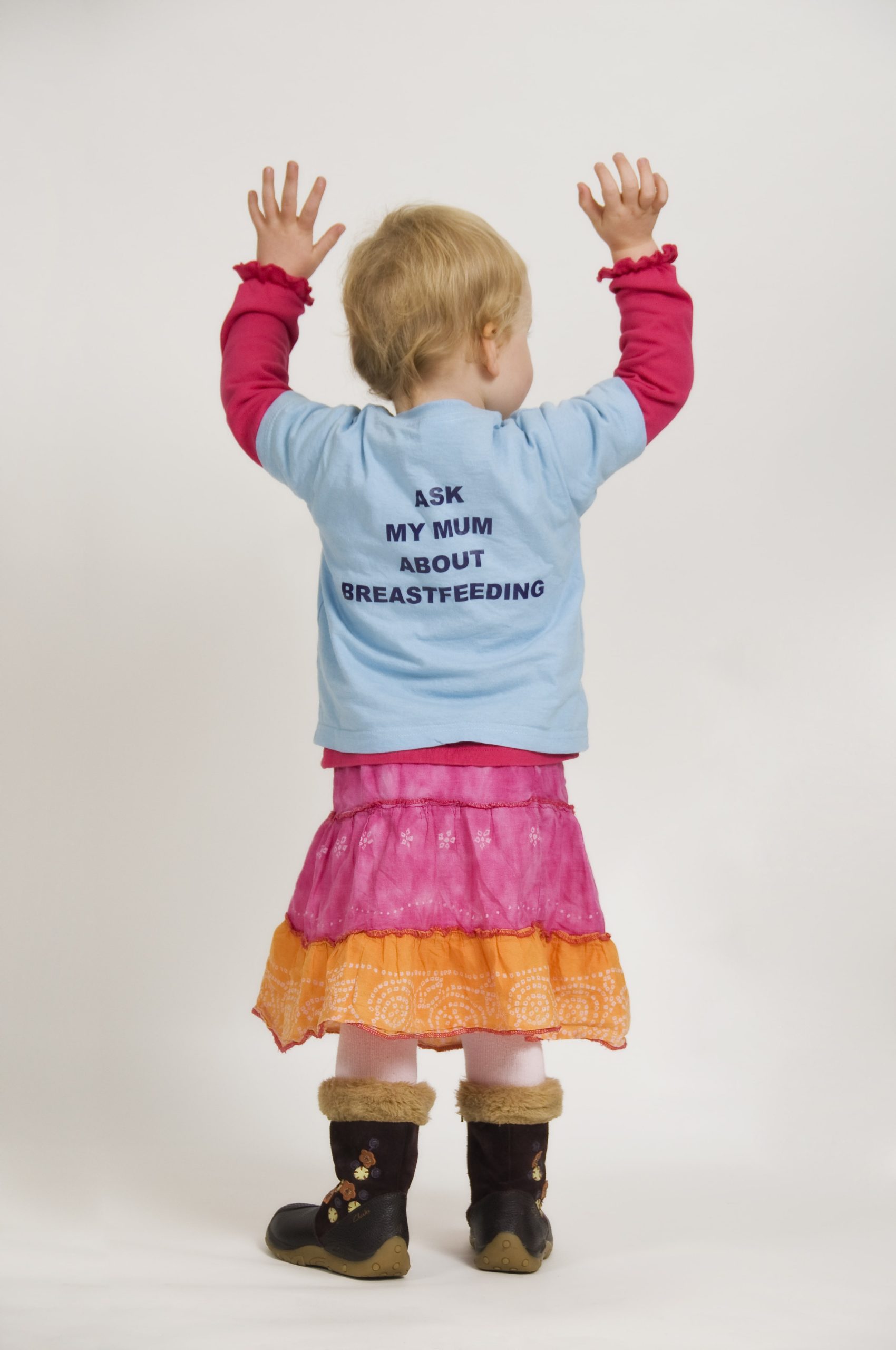 A child wearing an 'ask my mum about breastfeeding' top
